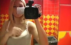 Blonde teen masturbates in a public bathroom