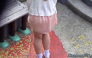 Cute asian urinating outdoors  