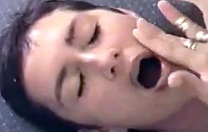 This girl gets a bunch of facial cum over her tiny face