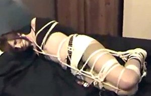 Tranny in ropes on a bed
