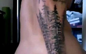 Muscular tattooed guy masturbating