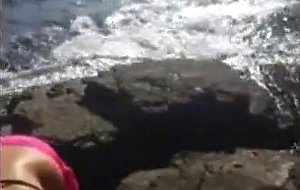 Bikini girl sucks cock on the rocky shore