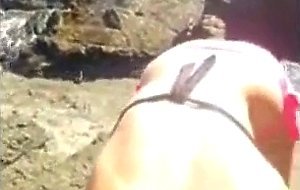 Bikini girl sucks cock on the rocky shore