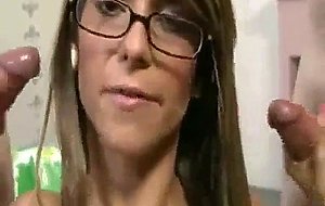 Hot girl with glasses hanldes two cocks